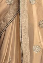 Shimmer Net Gold-coloured saree featuring an all-over heavy gold zari butta and sequence work on body decorated with border with contrast navy blue piping - Image 2